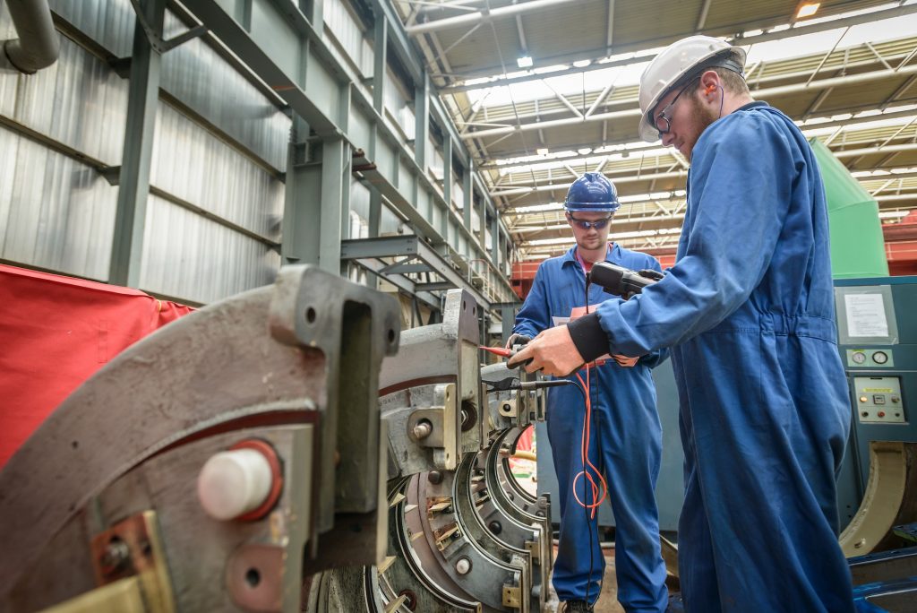 Engineers working on turbine housing repair during power station outage