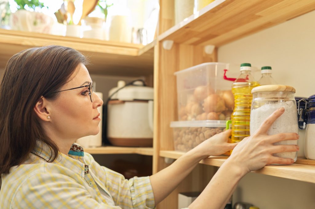 Food storage, woman taking food, sunflower oil for cooking